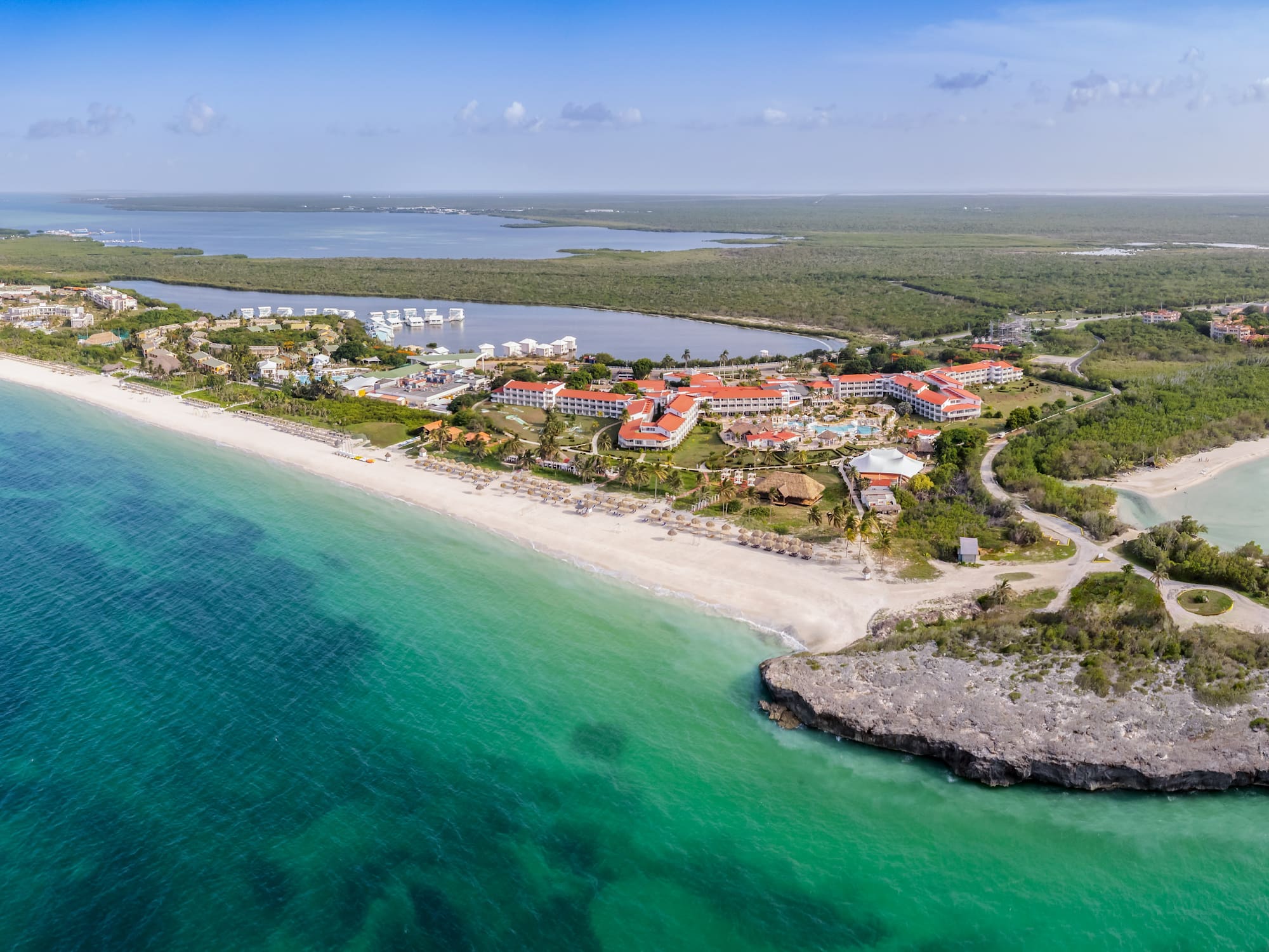 a beach with buildings and a body of water