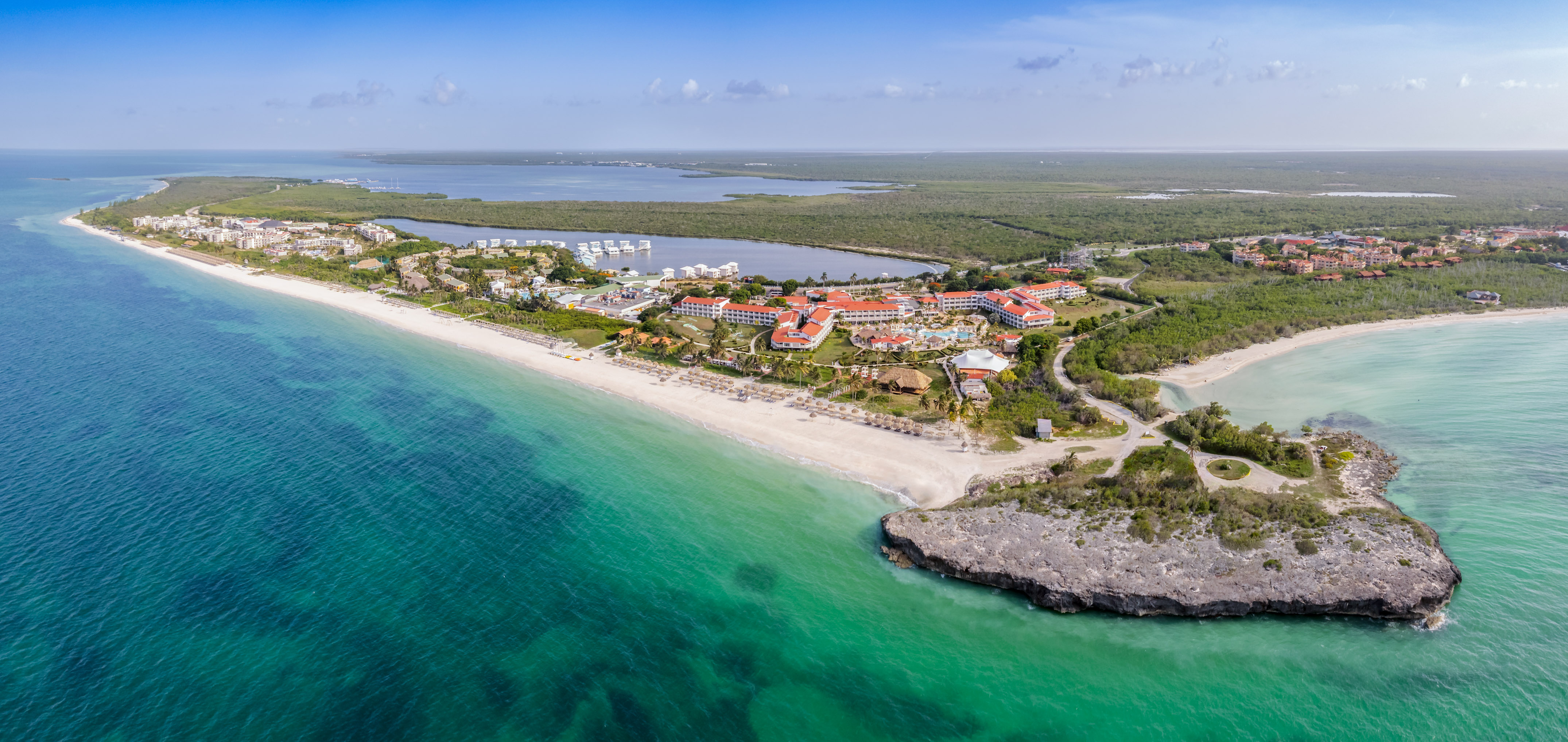 a beach with buildings and a body of water