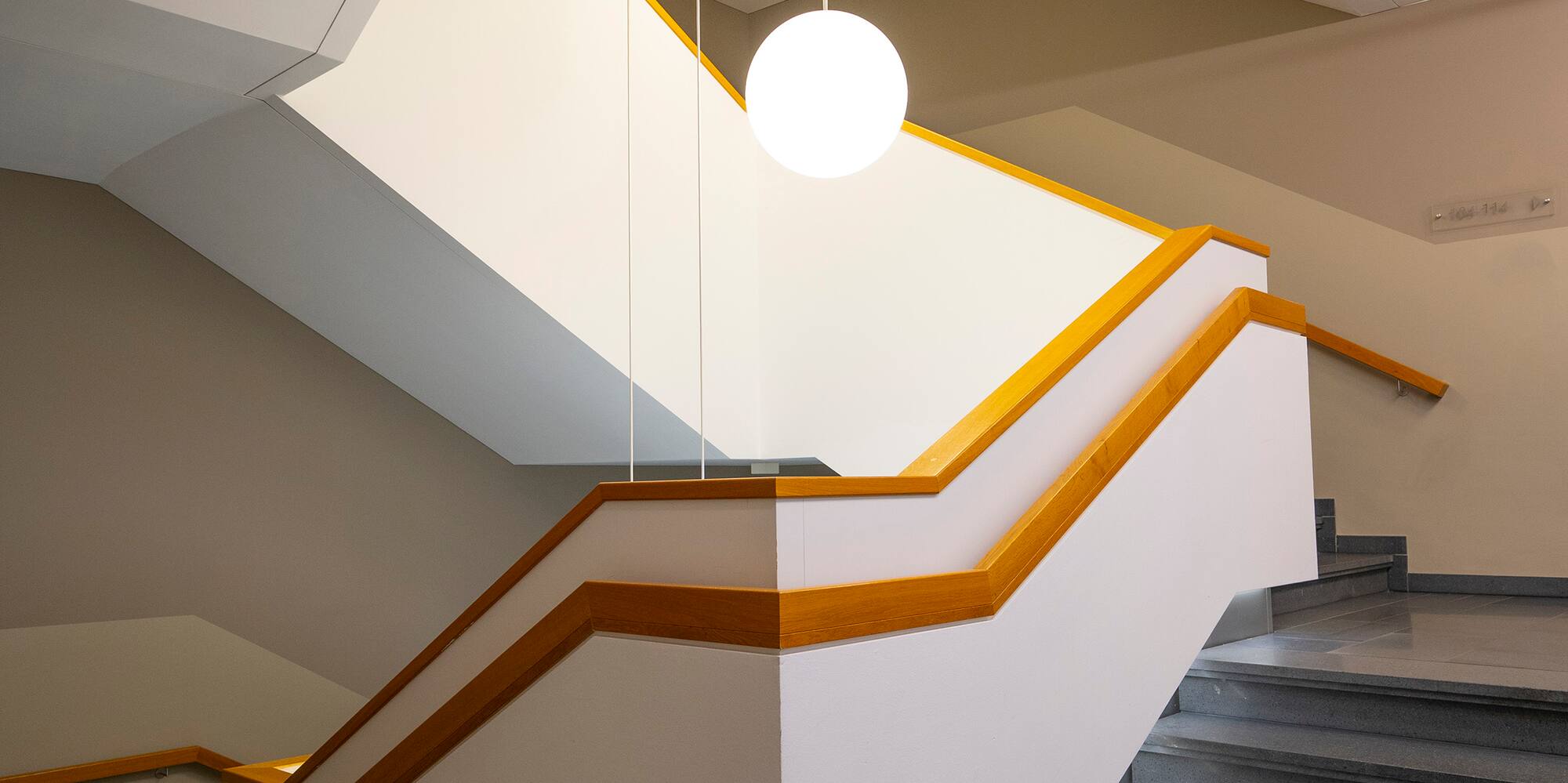 a staircase with light bulbs from the ceiling