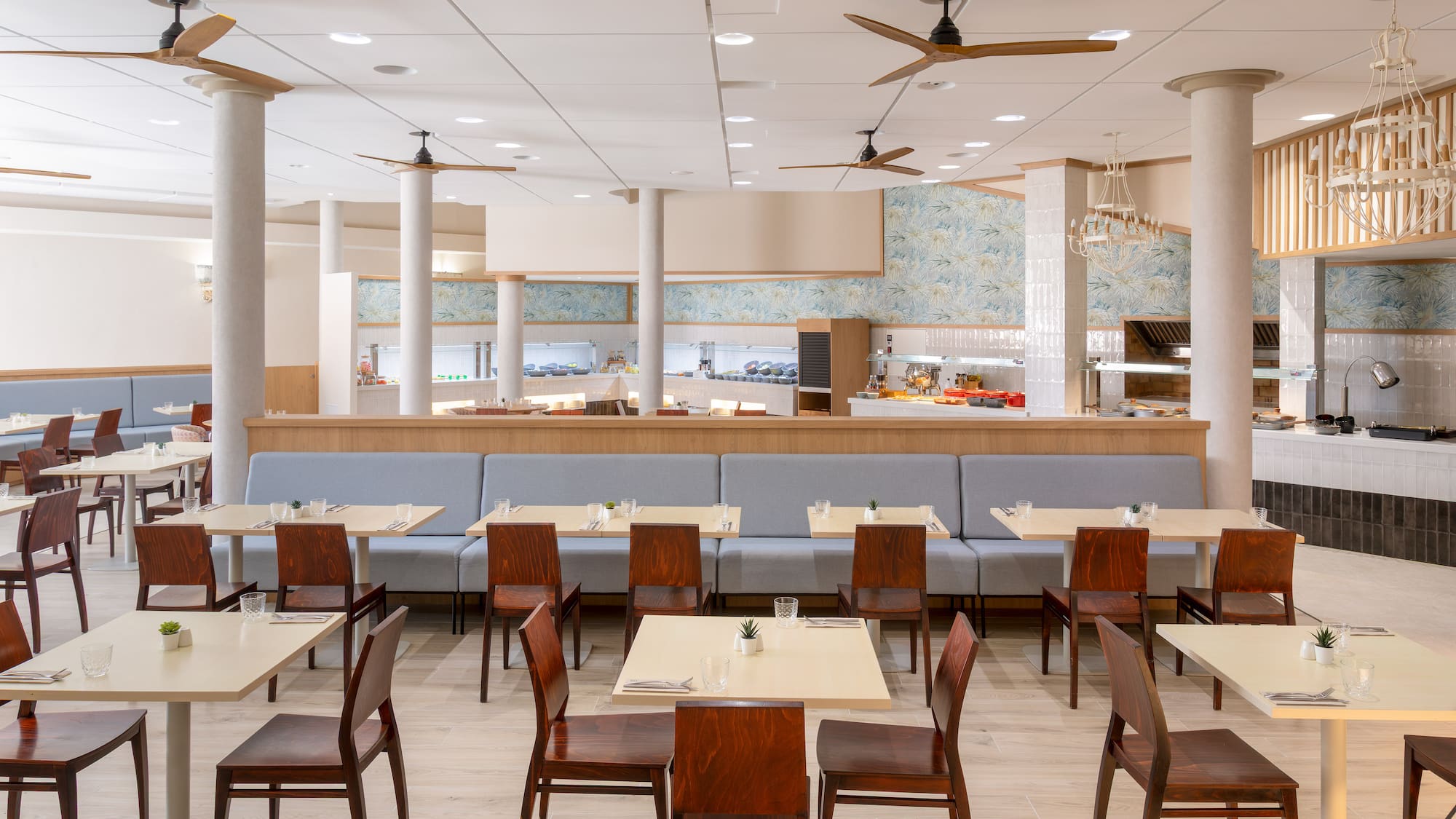 Bright, modern restaurant with buffet, light tables, and booth seating.