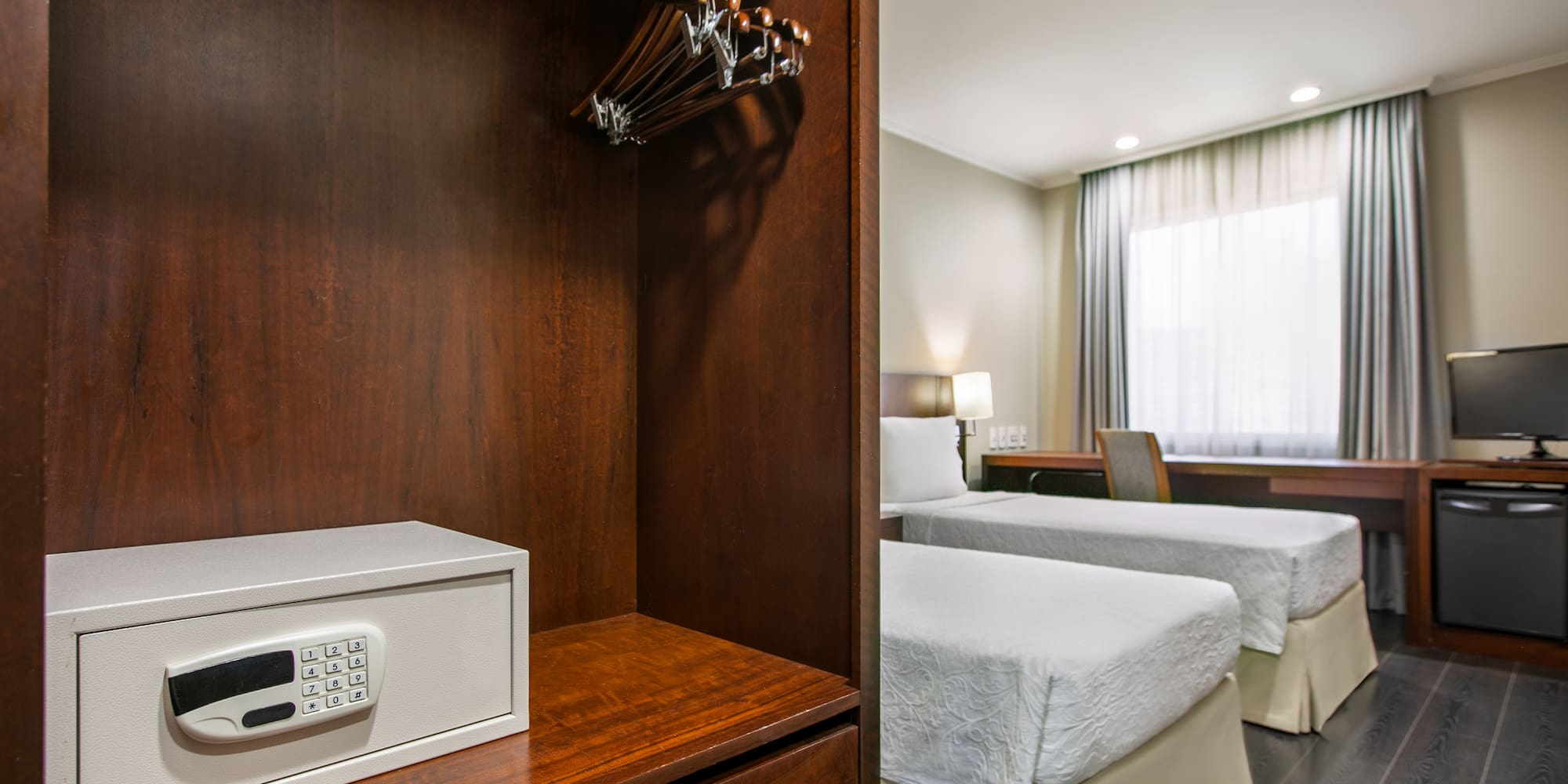 a room with two beds and a safe