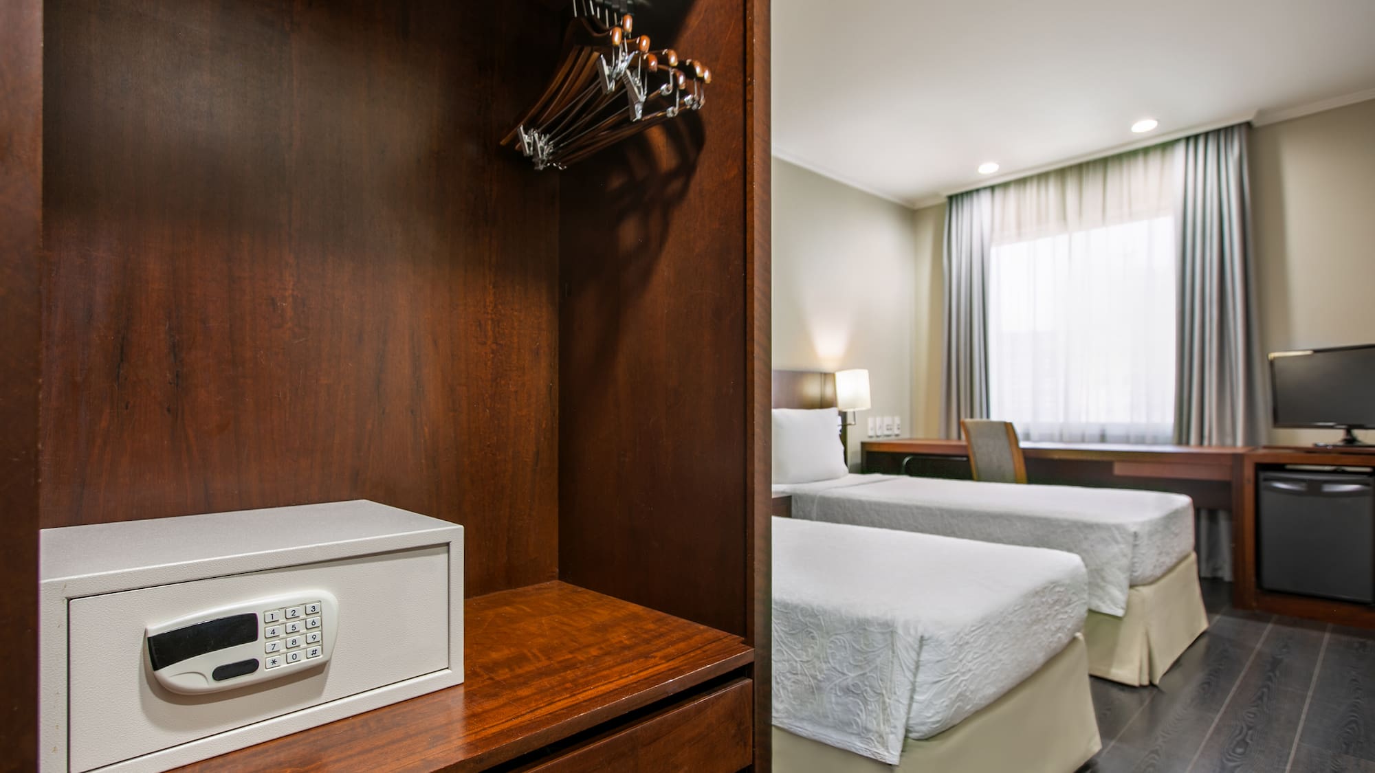 a room with two beds and a safe
