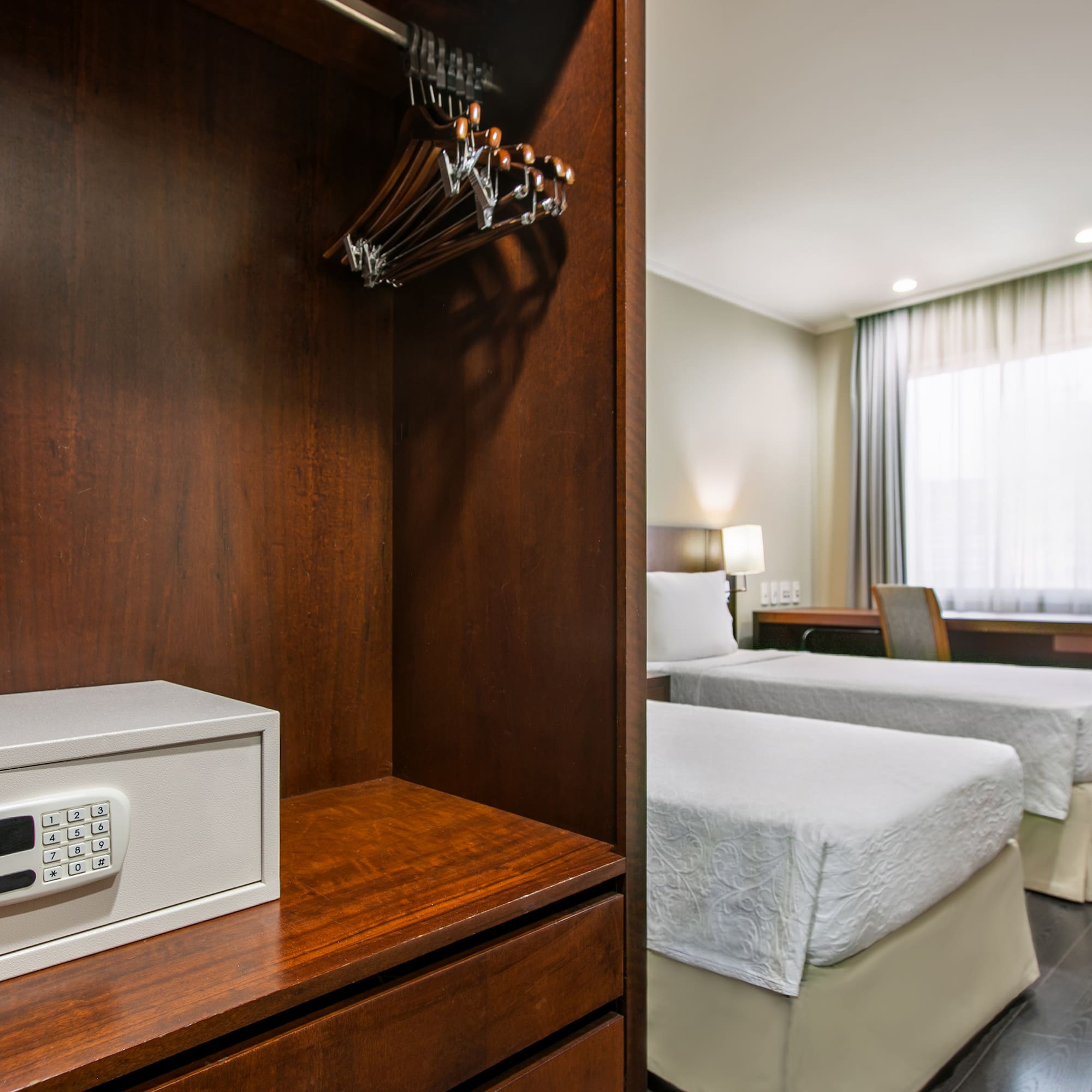 a room with two beds and a safe