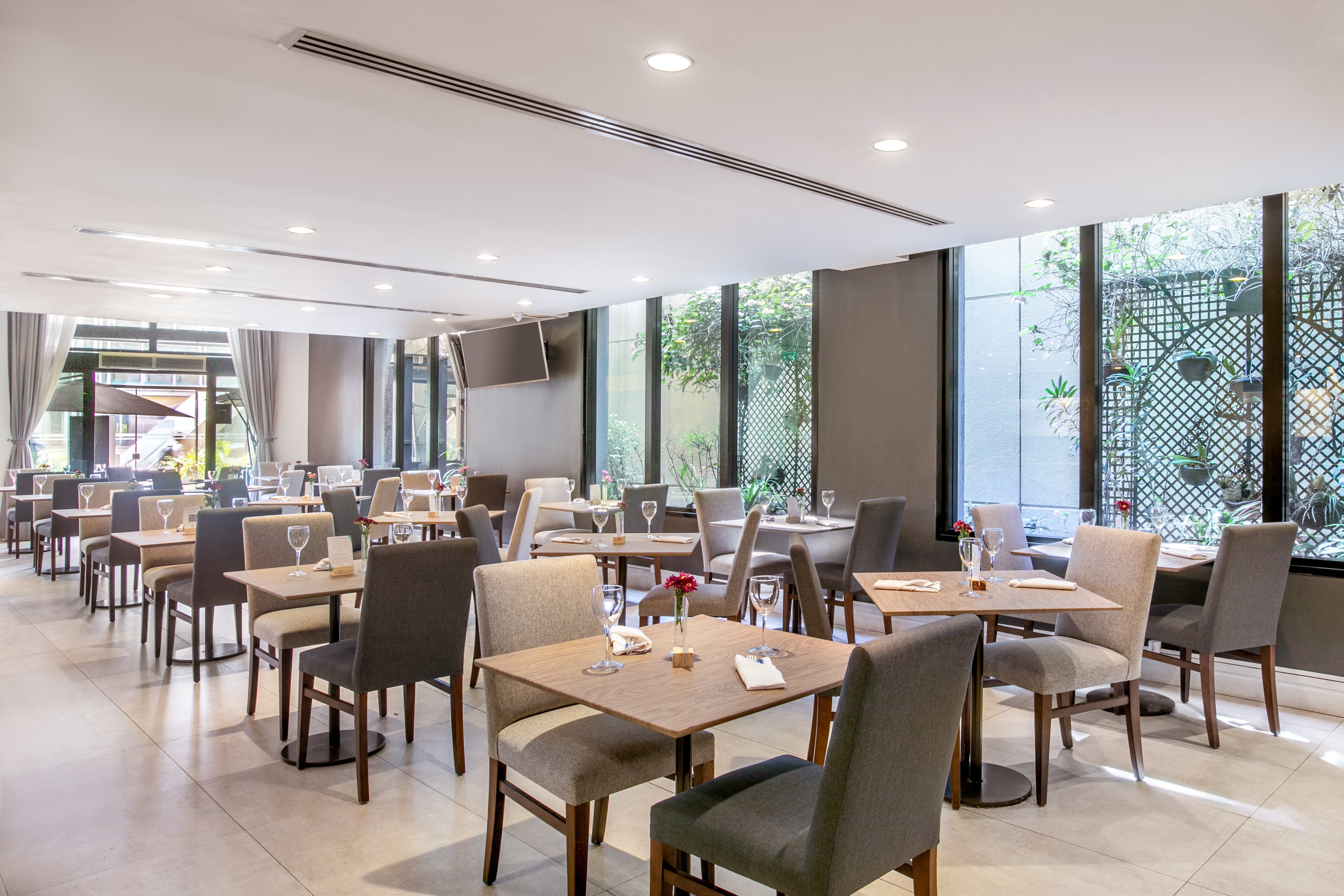 Modern white ceiling with recessed spotlights and linear air vents.