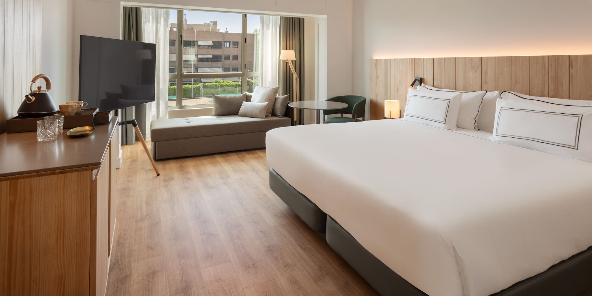 a room with a bed and a television