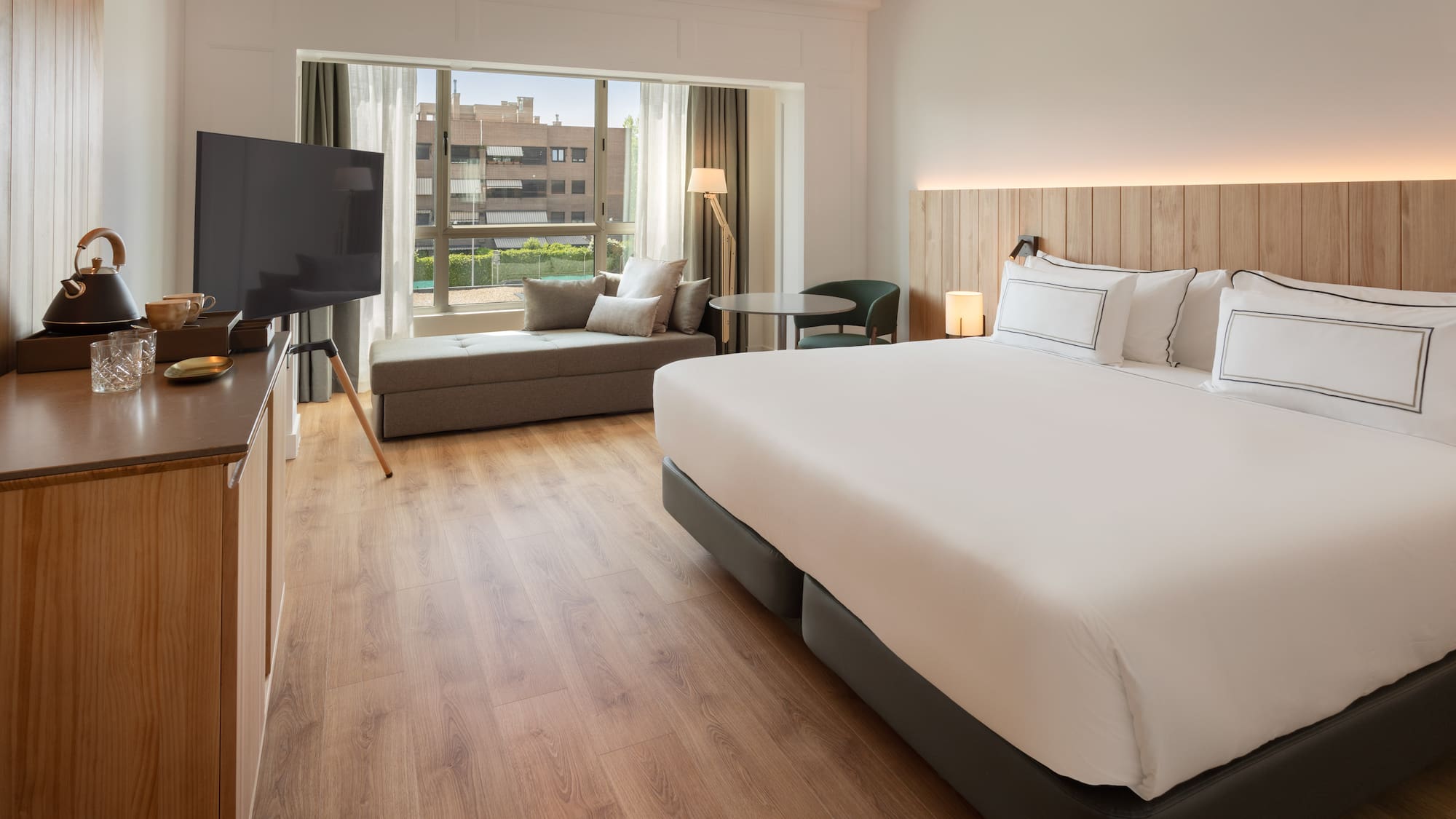 a room with a bed and a television