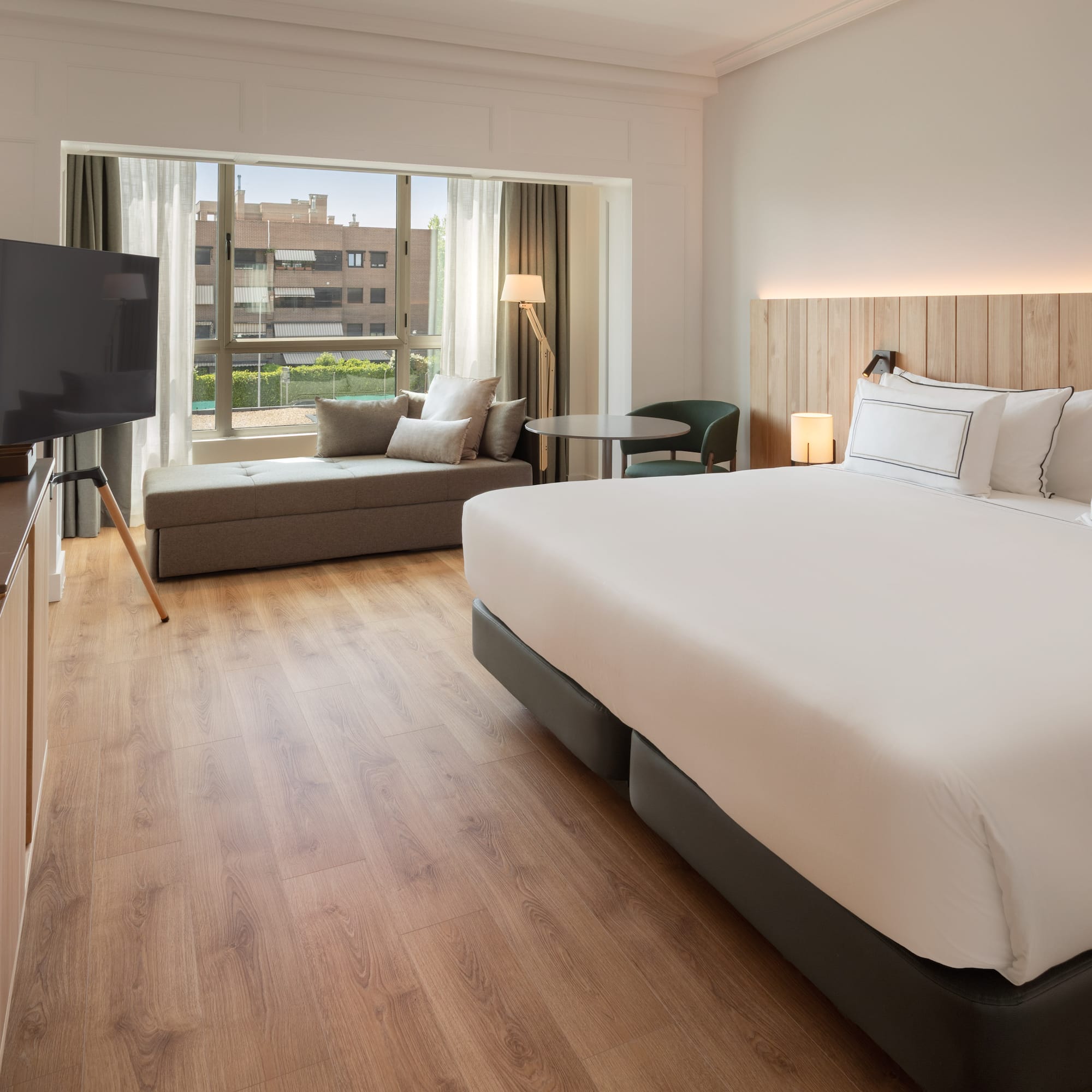 a room with a bed and a television