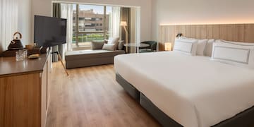 a room with a bed and a television