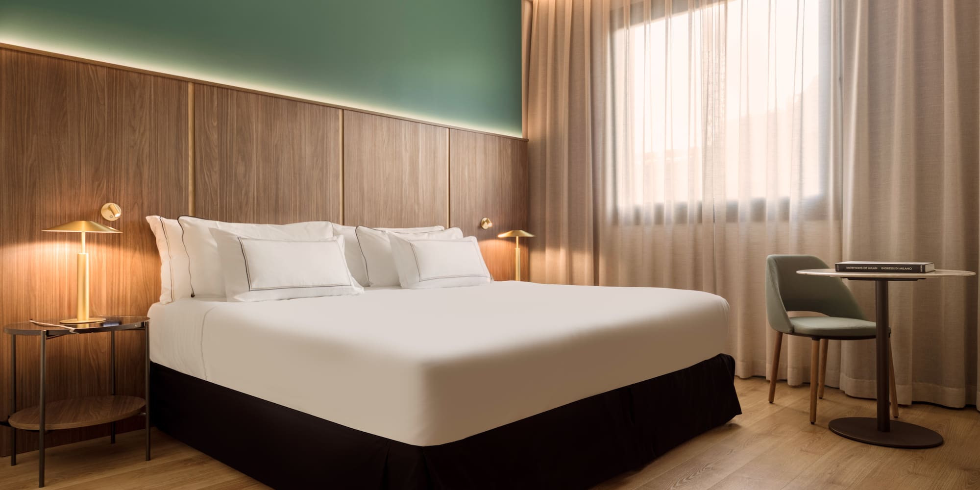 a bed with white sheets and a chair in a room