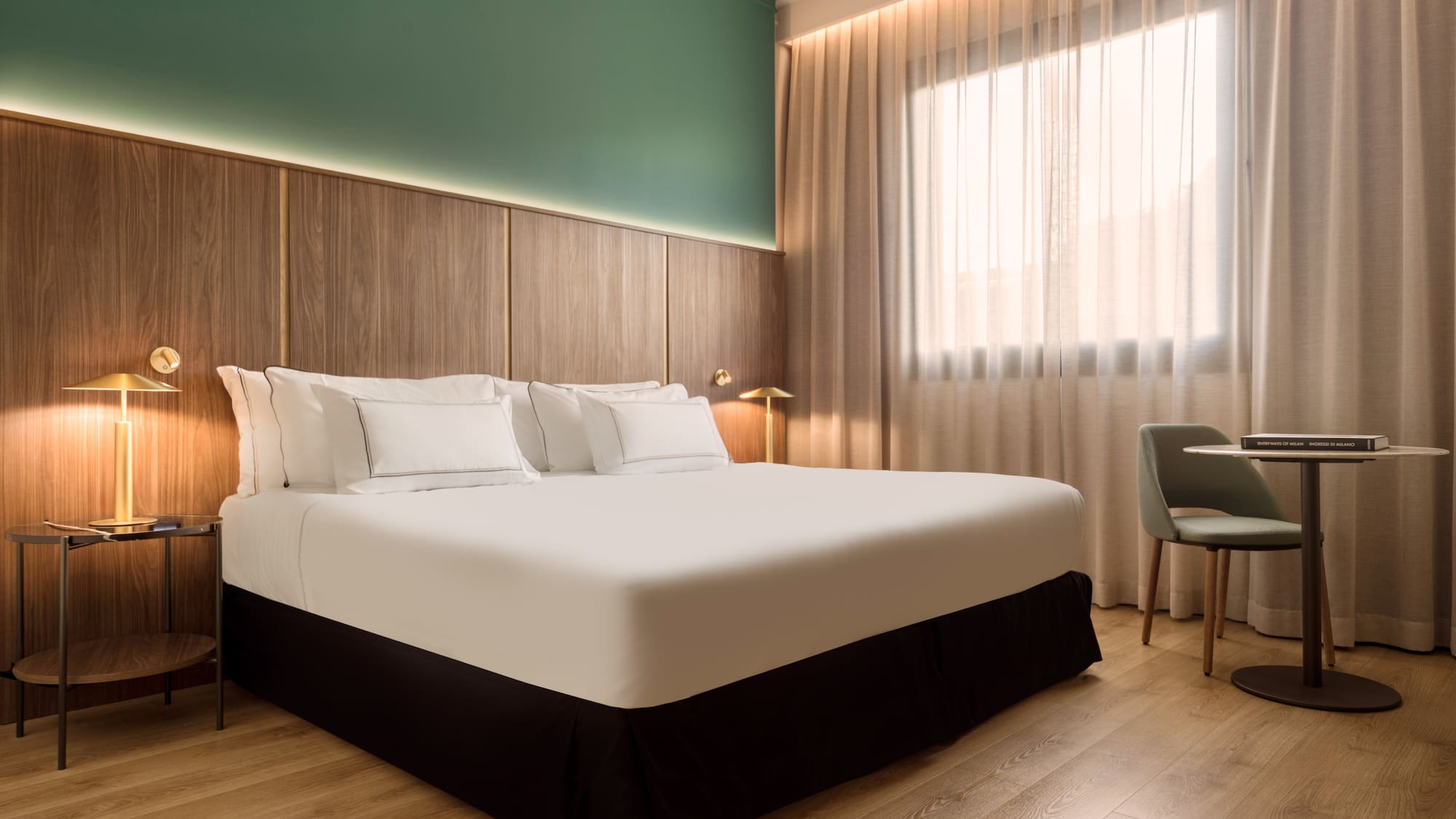 a bed with white sheets and a chair in a room