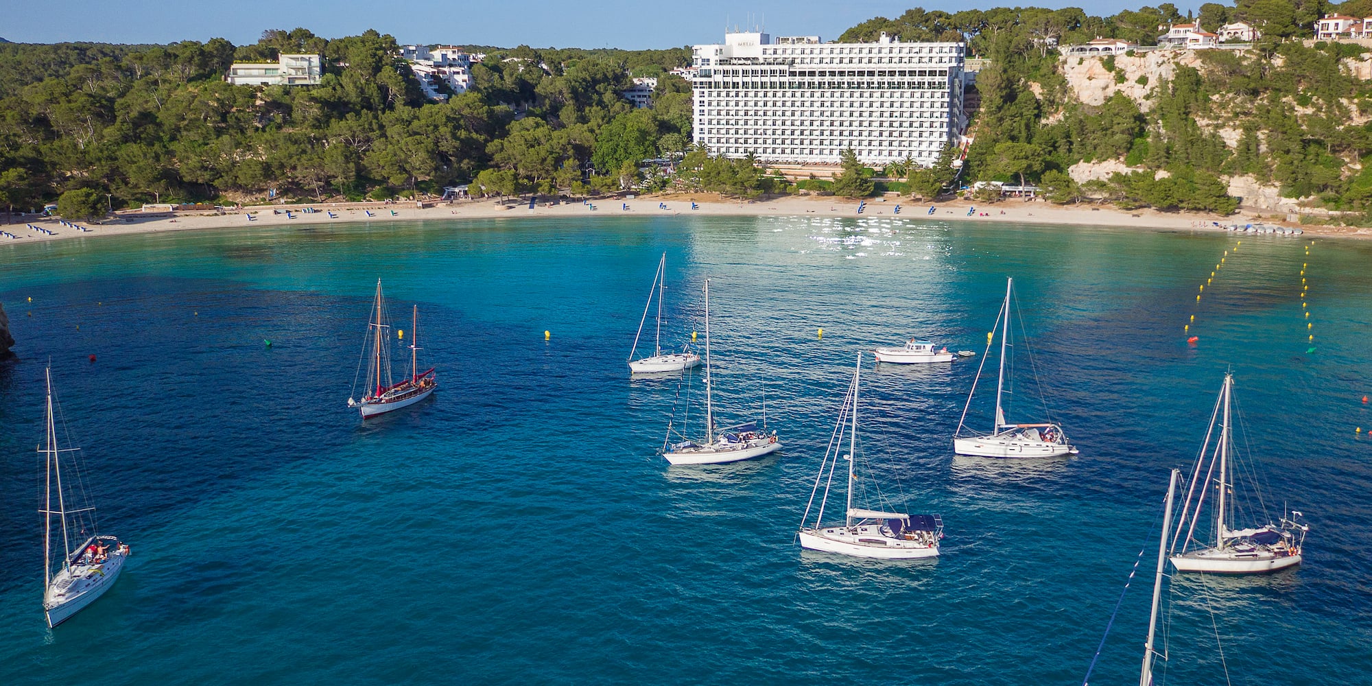 a group of sailboats in a bay