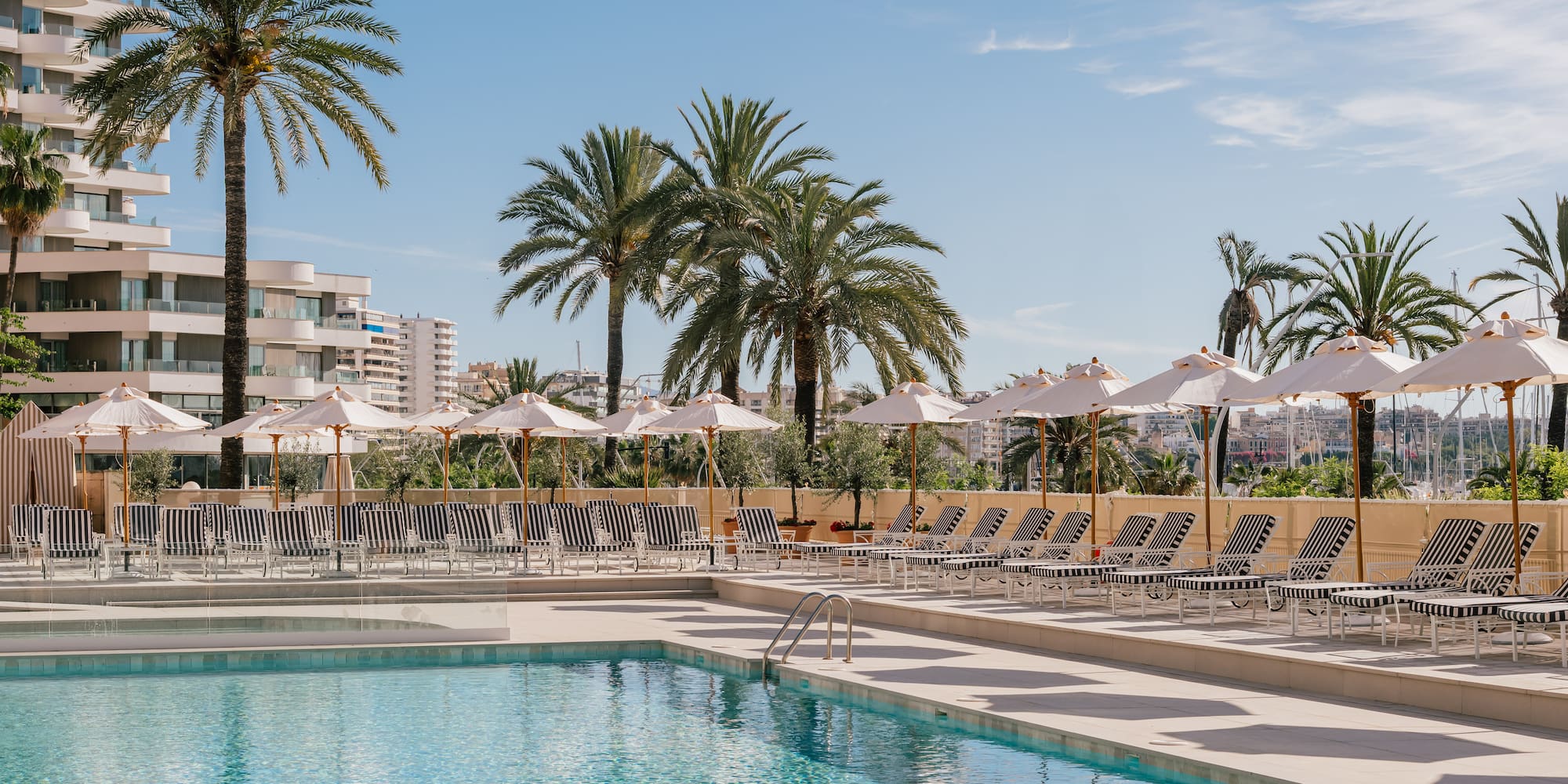 a pool with umbrellas and chairs