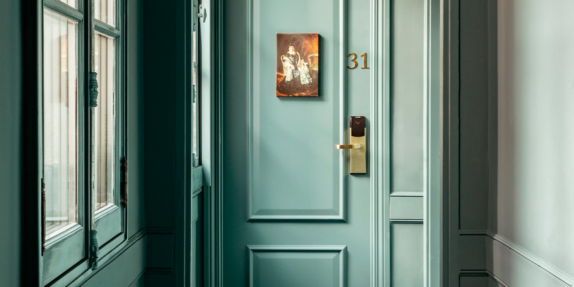 a hallway with a door and a picture on the door