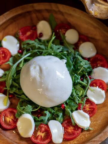 a plate of food with mozzarella cheese and tomatoes