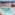 Mediterranean resort pools, water park, palm trees, and distant ocean view.