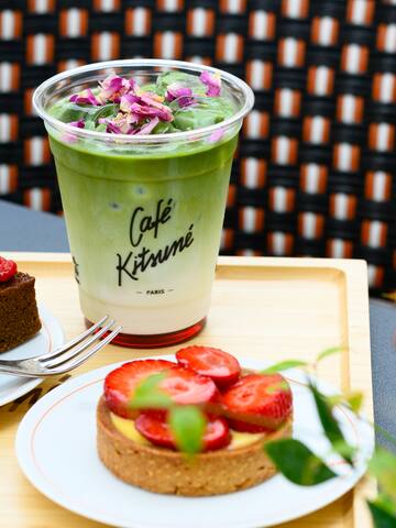 a cup of green drink and a dessert on a plate