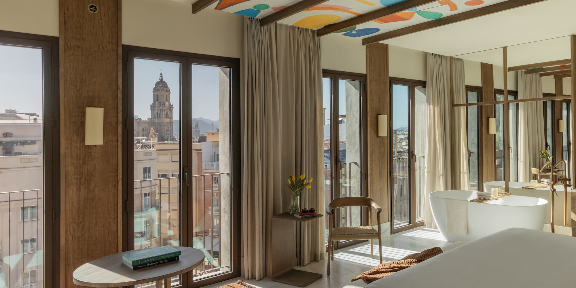 a room with a bed and a table and chairs