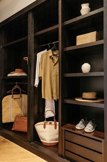 a closet with shelves and clothes