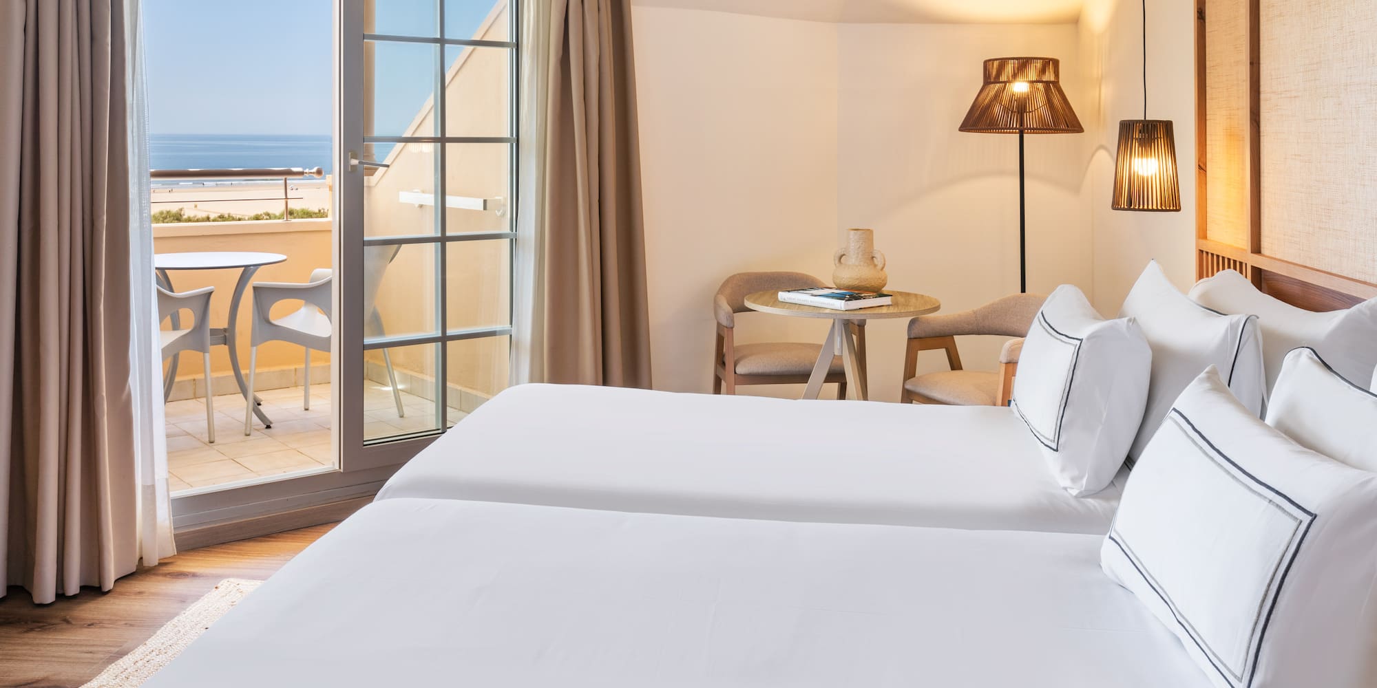 a room with two beds and a glass door