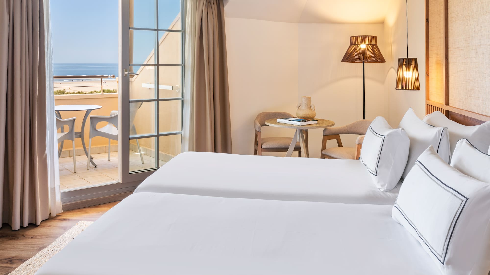 a room with two beds and a glass door