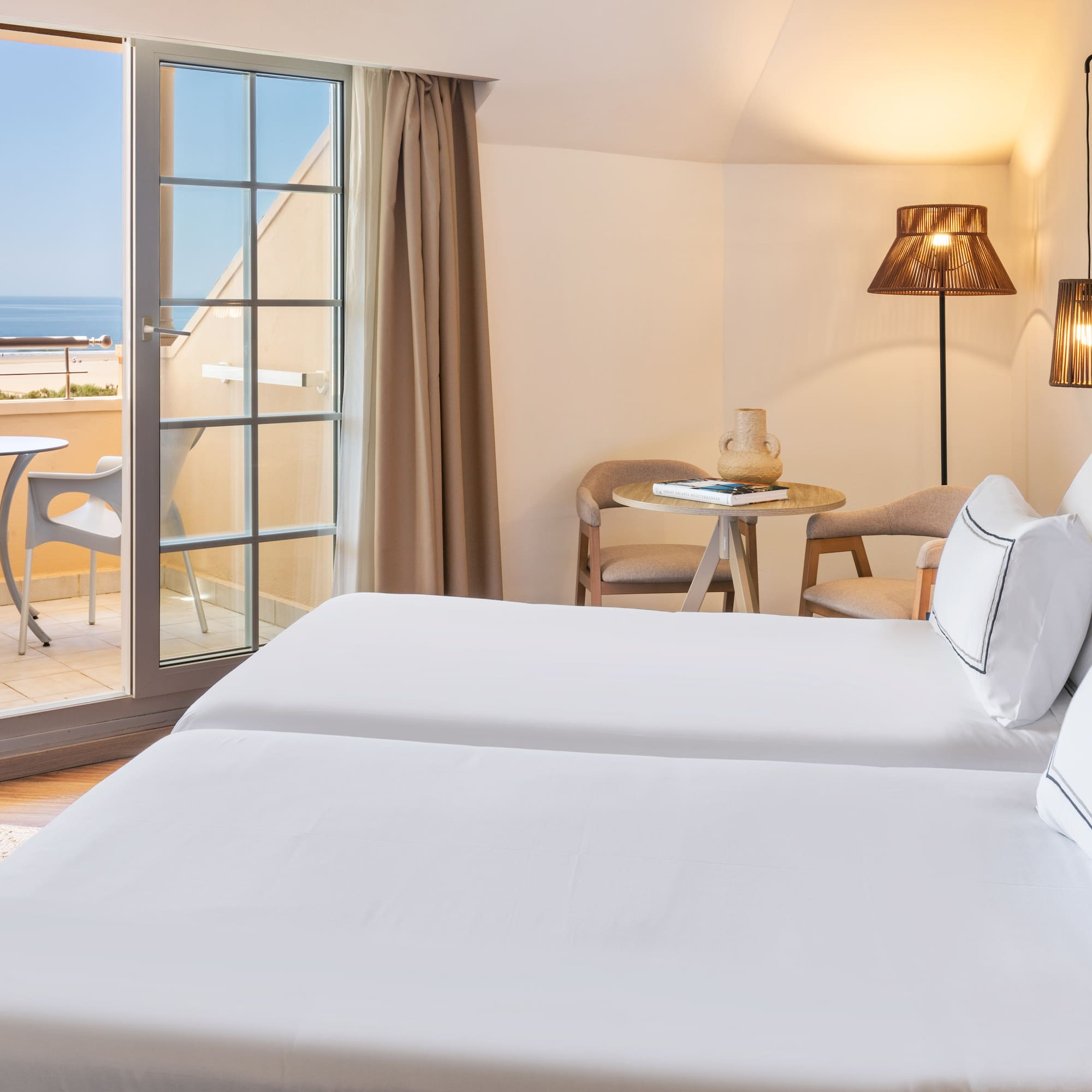 a room with two beds and a glass door