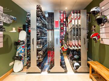 a room with snowboards and helmets