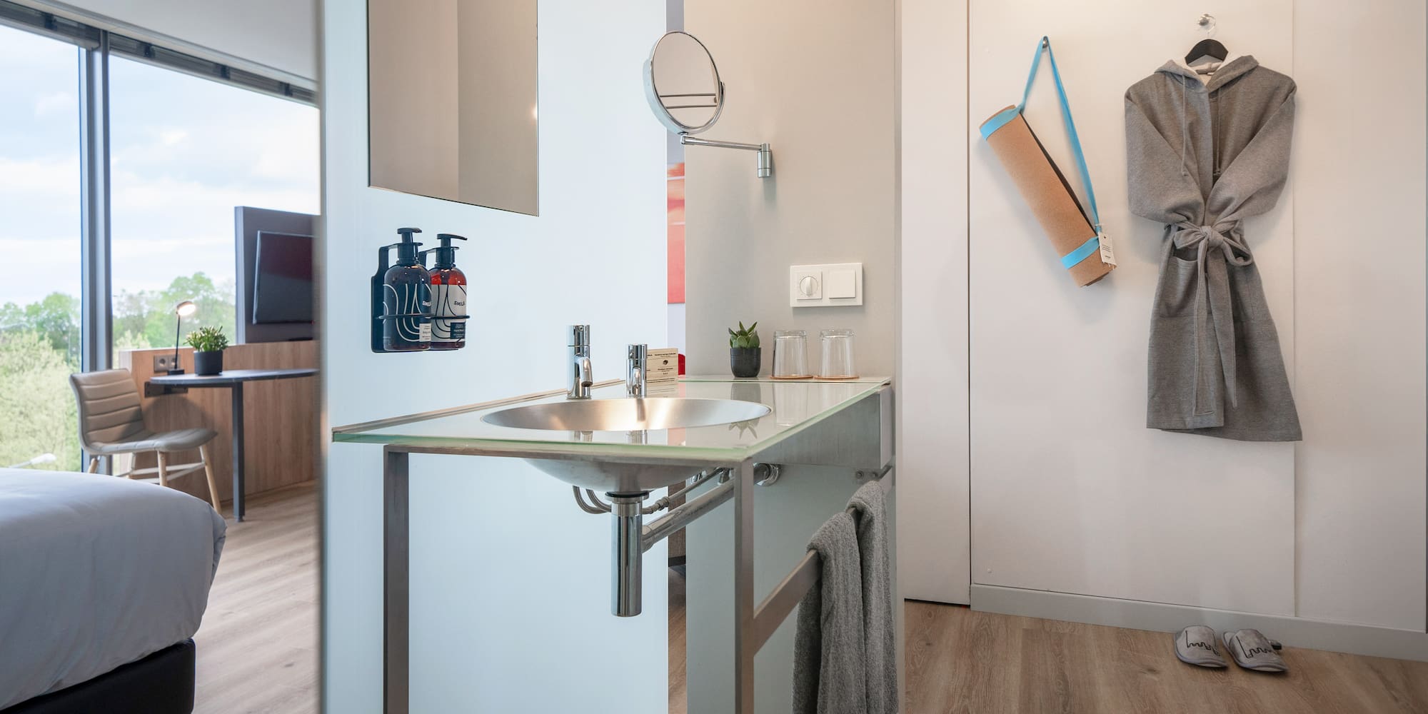 a bathroom with a sink and a towel on the wall