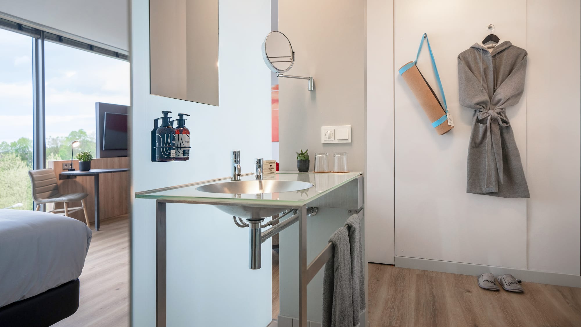 a bathroom with a sink and a towel on the wall