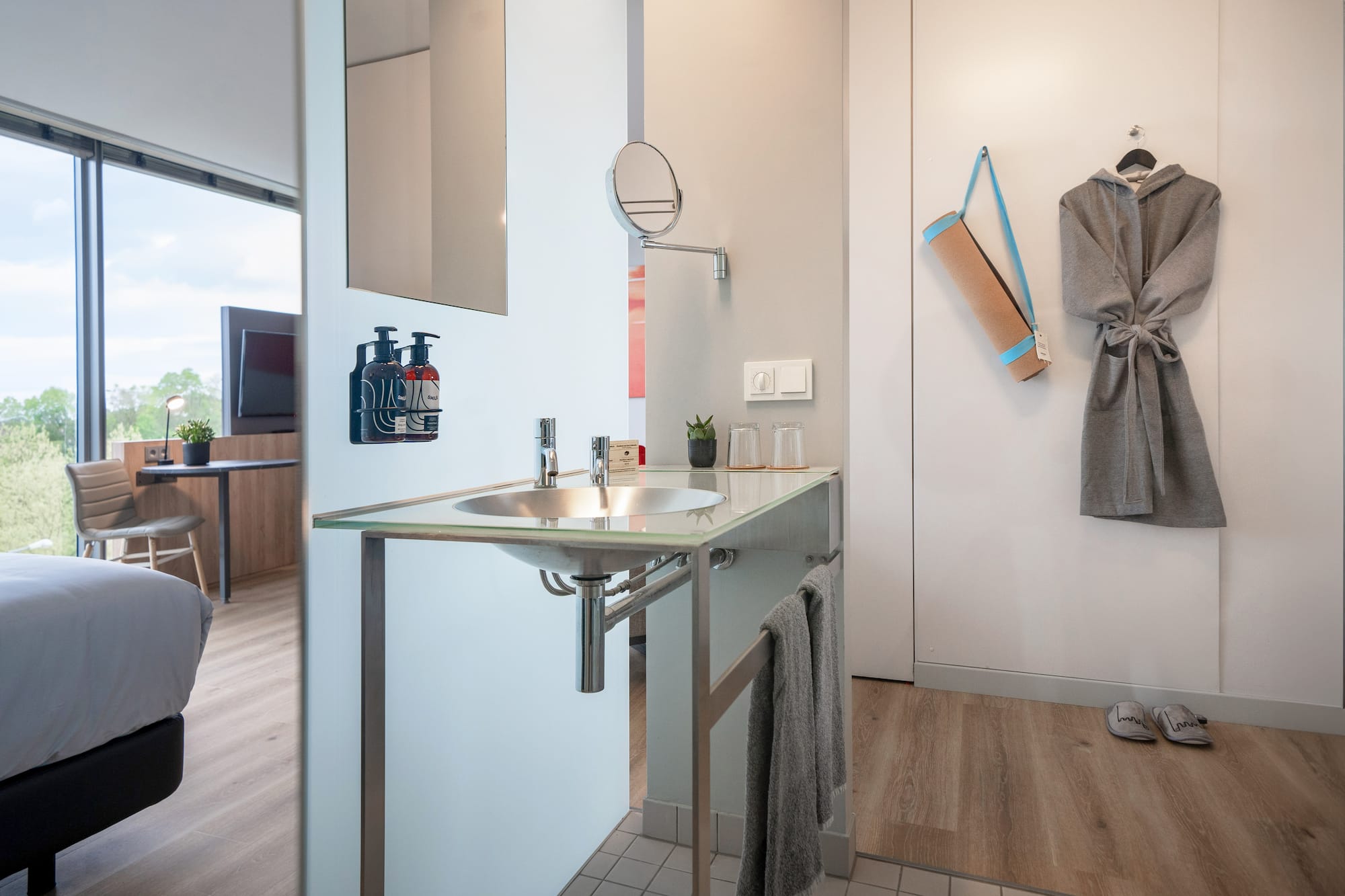 a bathroom with a sink and a towel on the wall