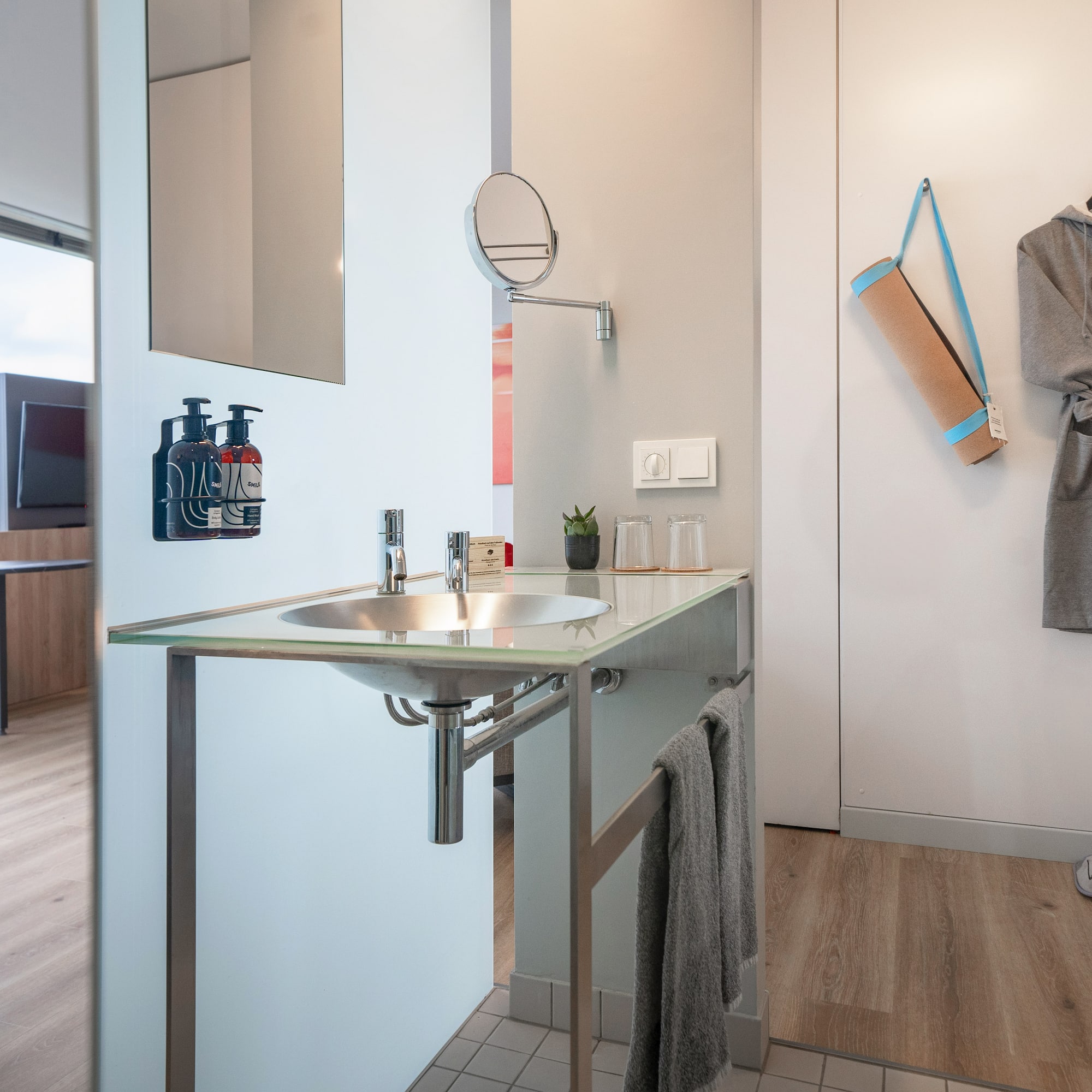 a bathroom with a sink and a towel on the wall