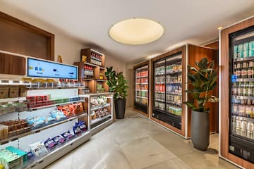 a room with shelves of snacks and a plant