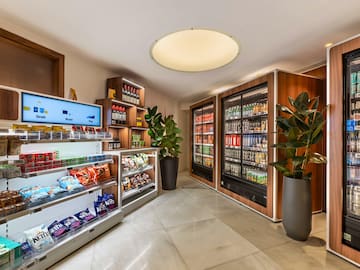 a room with shelves of snacks and a plant