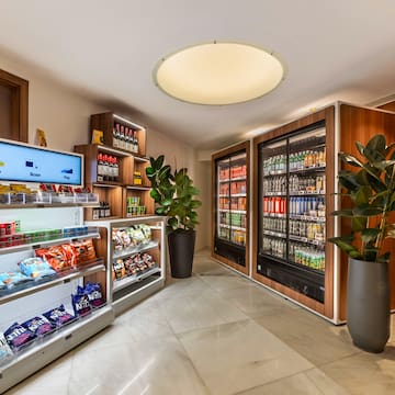 a room with shelves of snacks and a plant