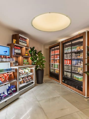 a room with shelves of snacks and a plant