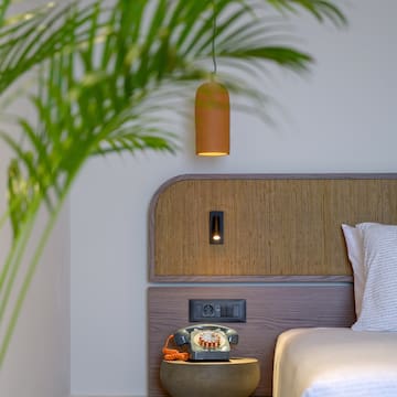 a bed with a telephone on the side of the bed