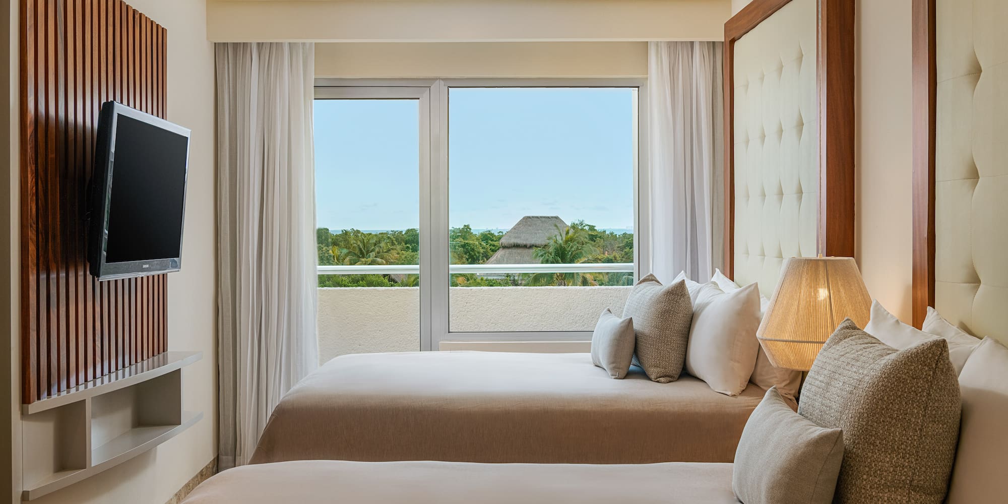 a room with two beds and a television