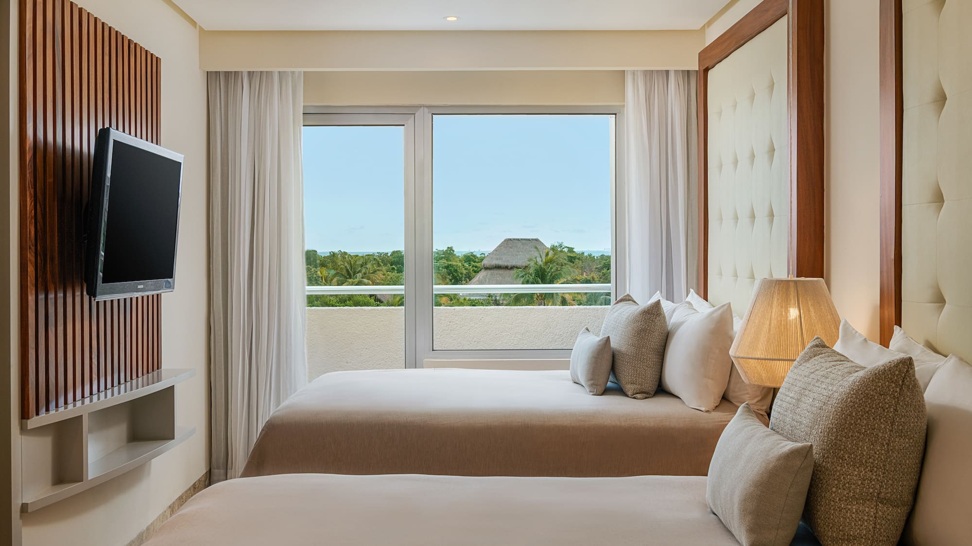 a room with two beds and a television