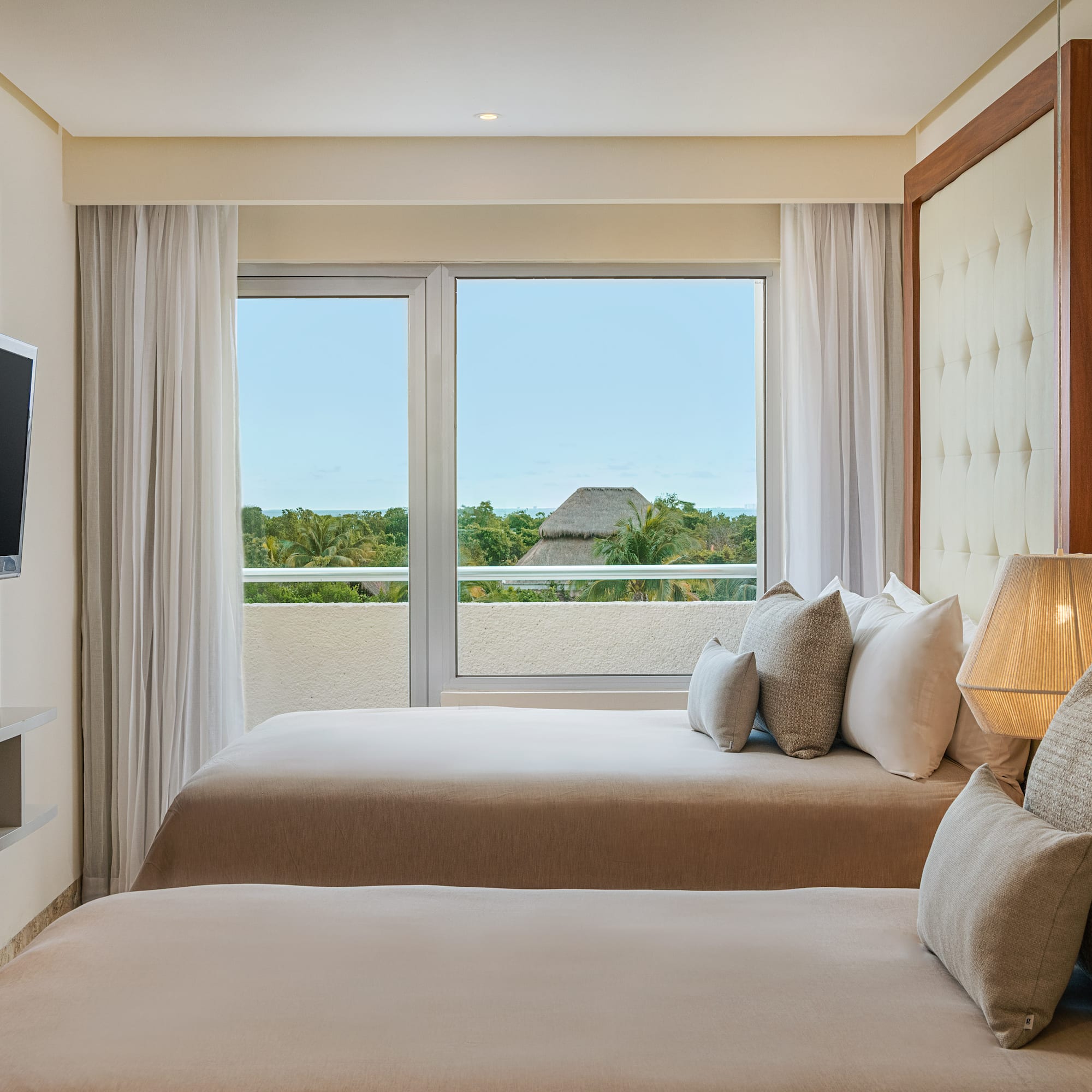 a room with two beds and a television