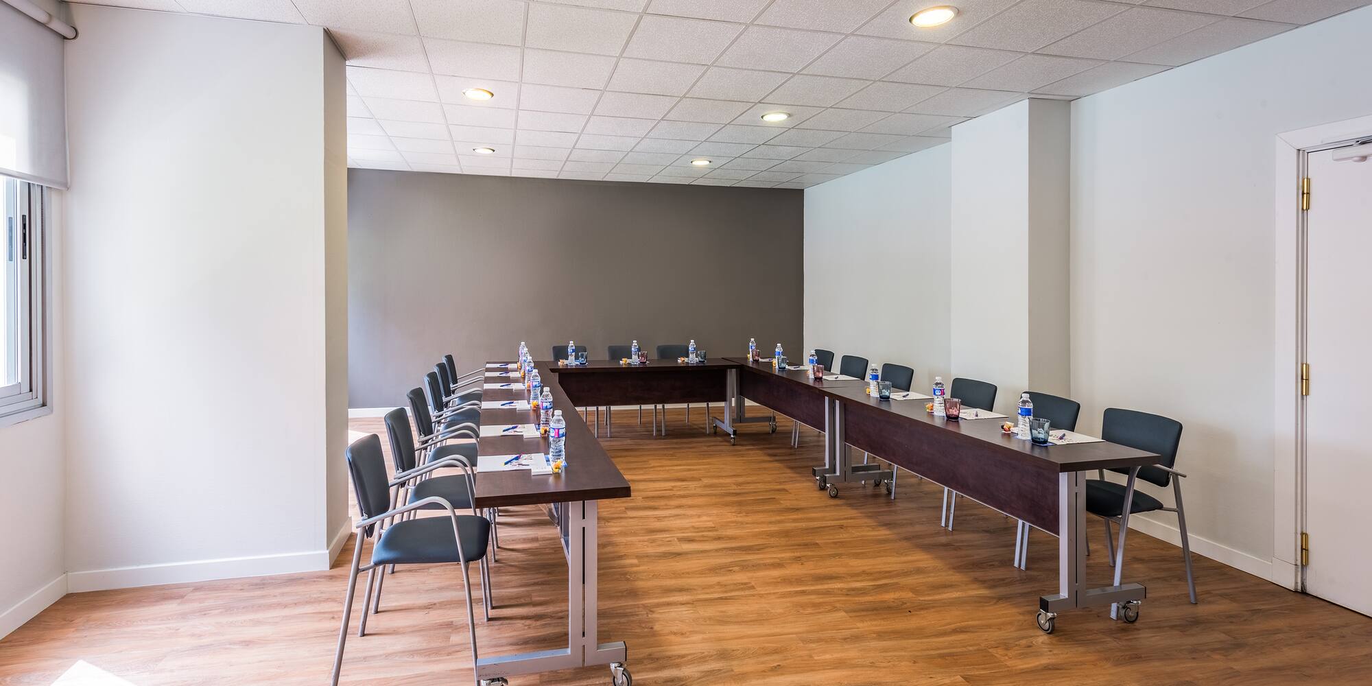 a room with long tables and chairs