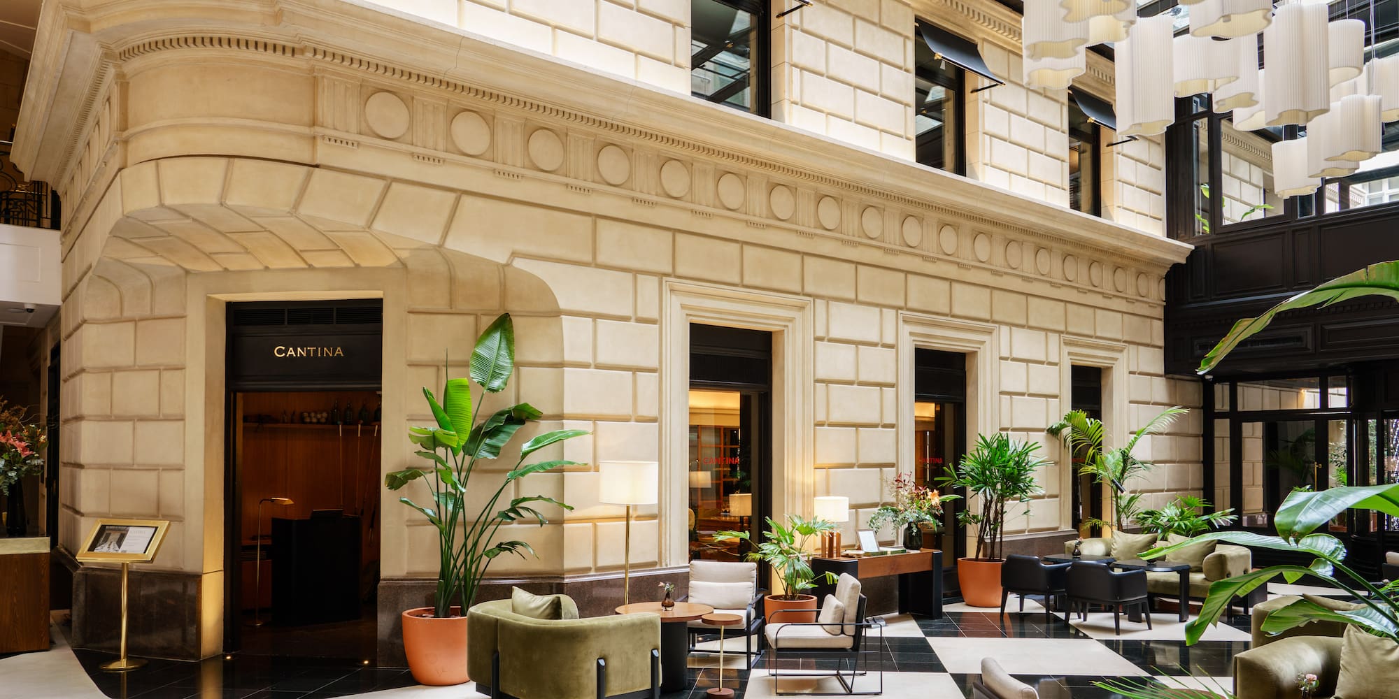 Luxurious hotel lobby lounge with Cantina entrance, checkered floor, and modern seating.