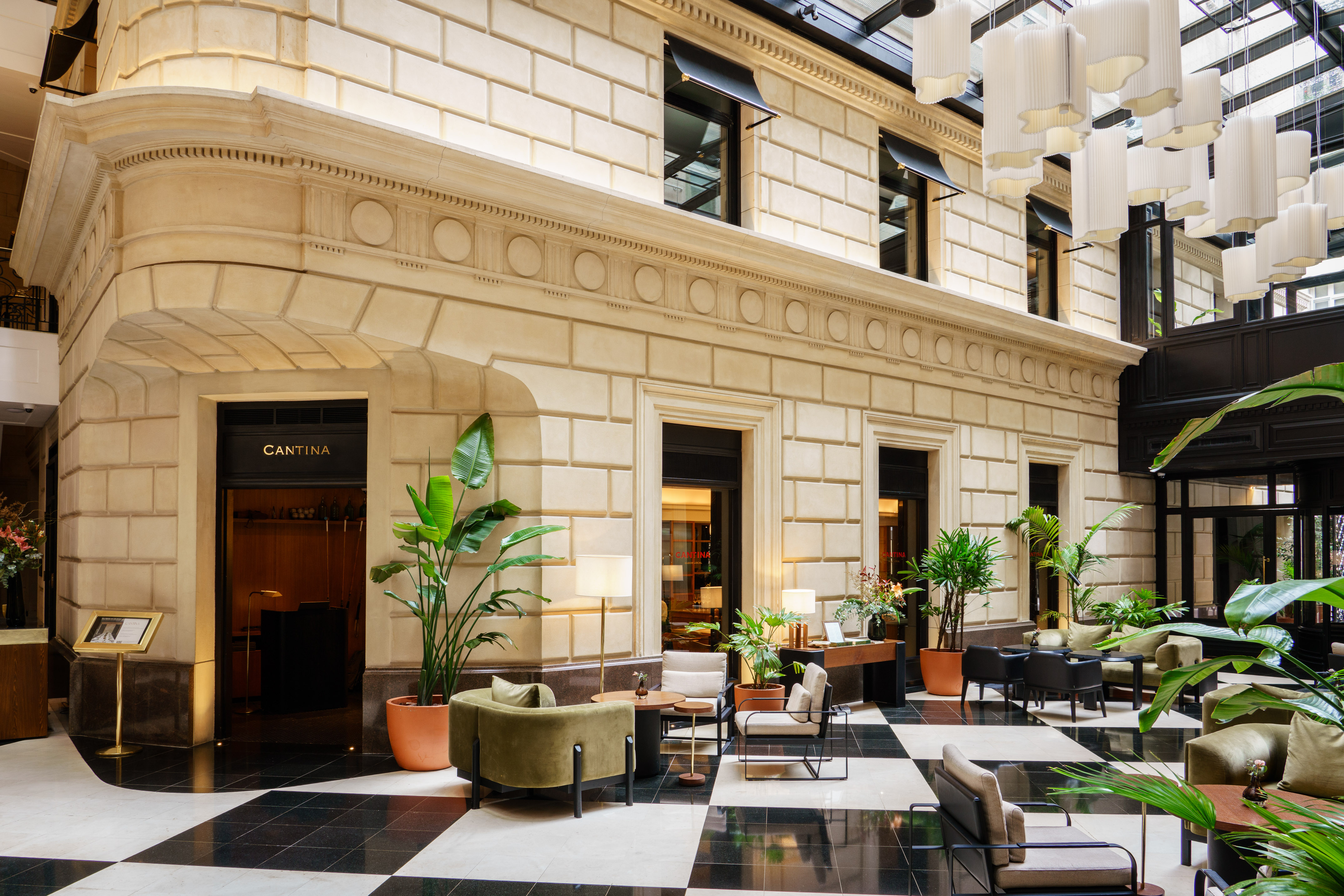 Luxurious hotel lobby lounge with Cantina entrance, checkered floor, and modern seating.