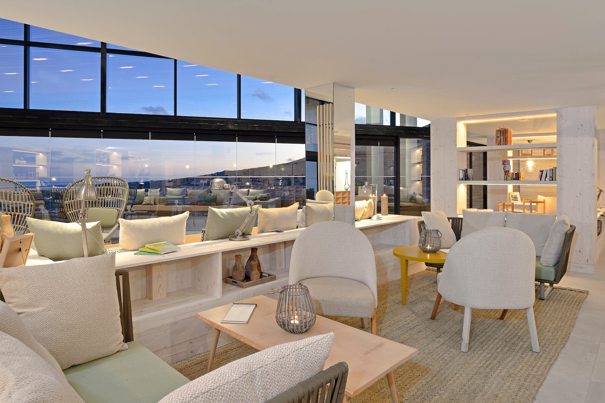 a room with a large window and a table with chairs and a table