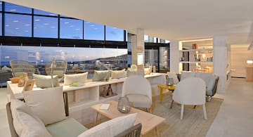 a room with a large window and a table with chairs and a table