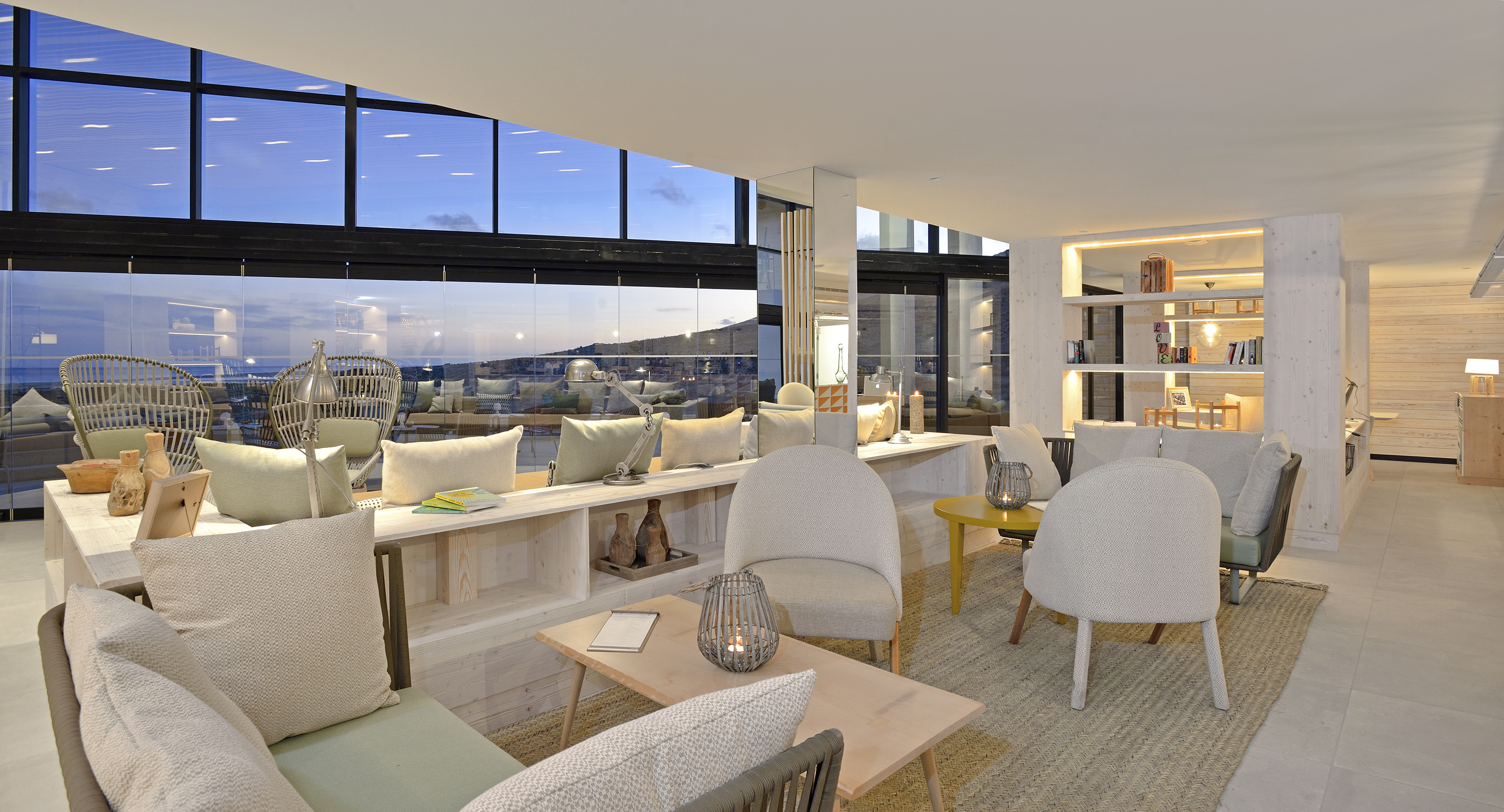 a room with a large window and a table with chairs and a table