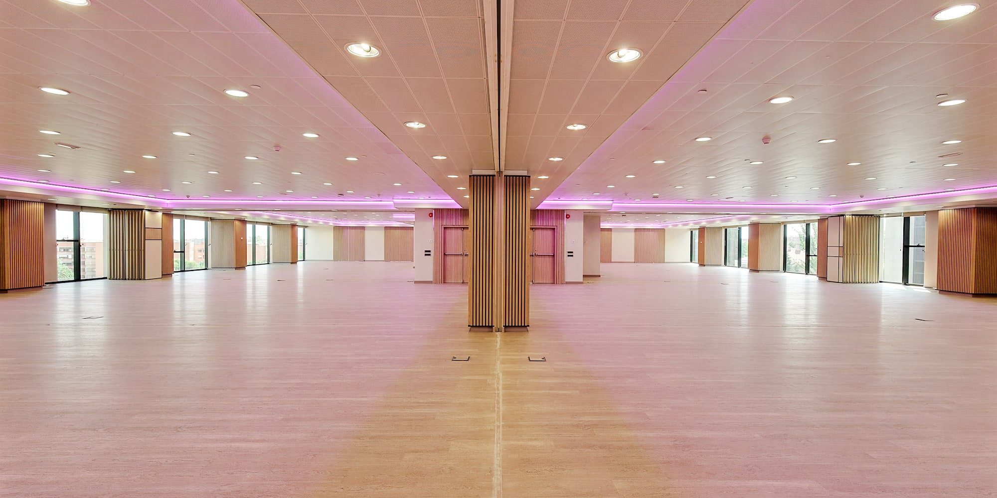 a large room with pink lights