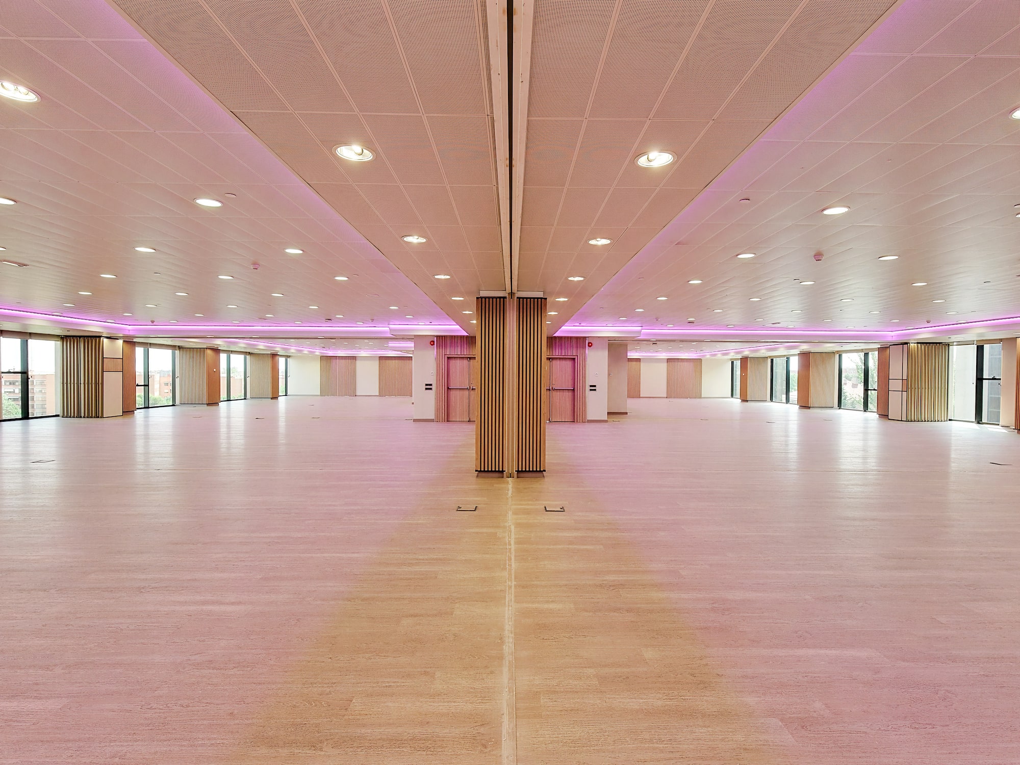 a large room with pink lights