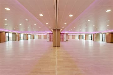 a large room with pink lights