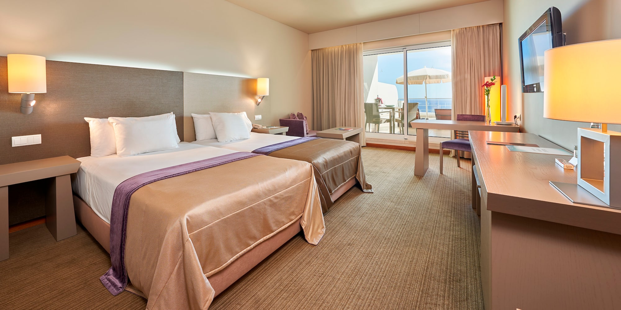 a room with two beds and a desk