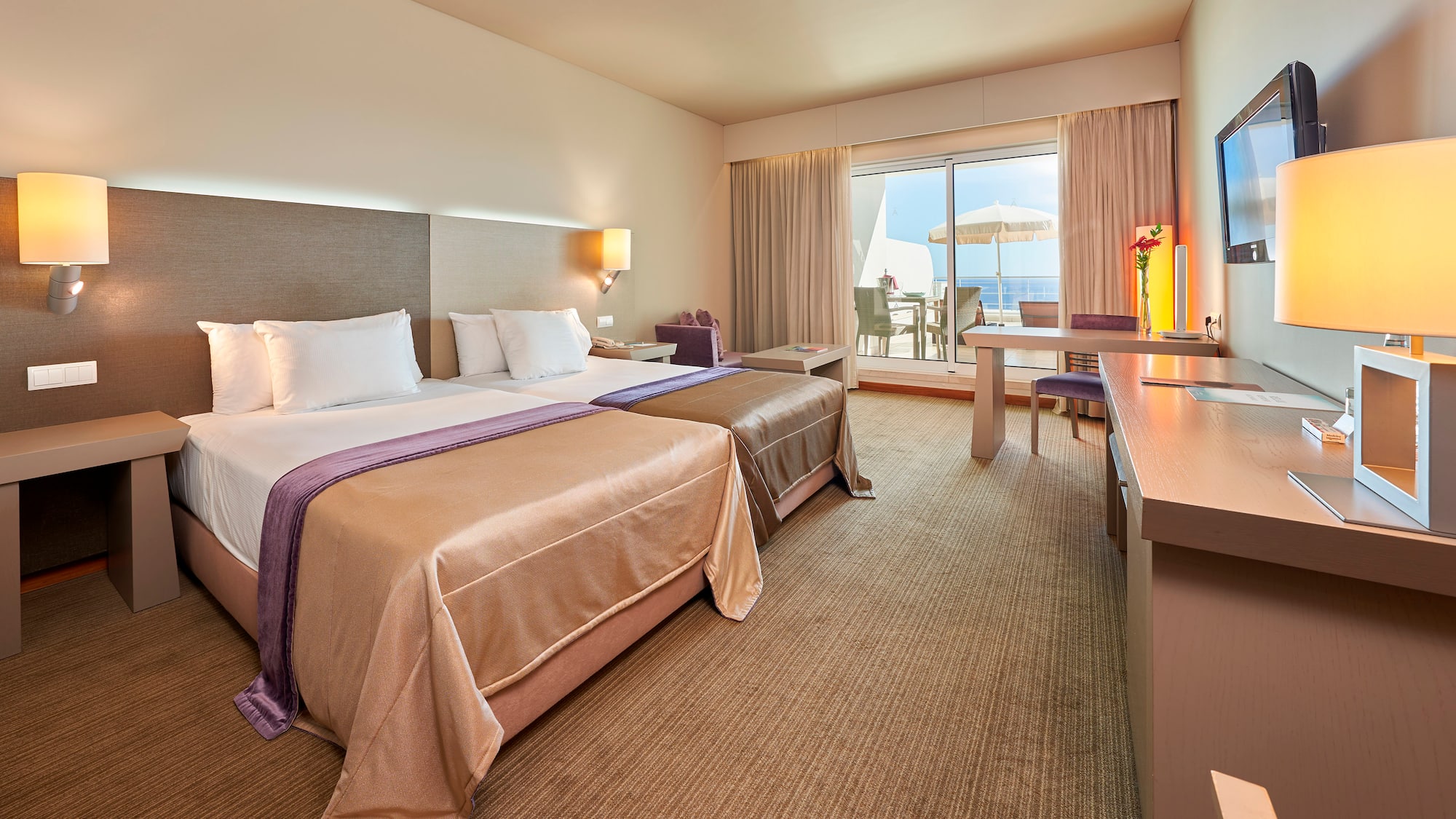 a room with two beds and a desk