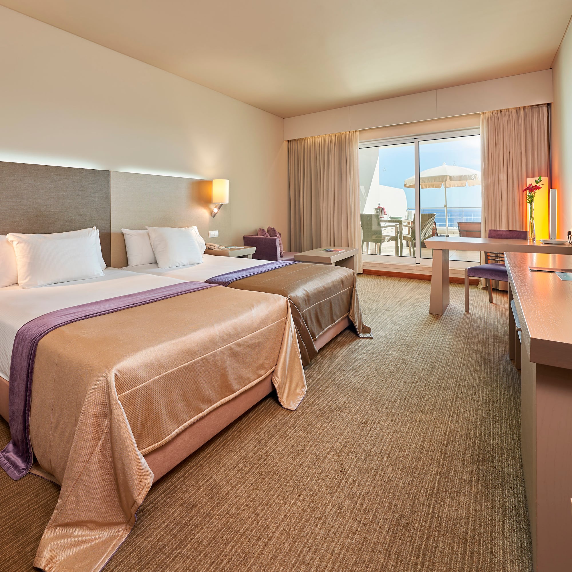 a room with two beds and a desk